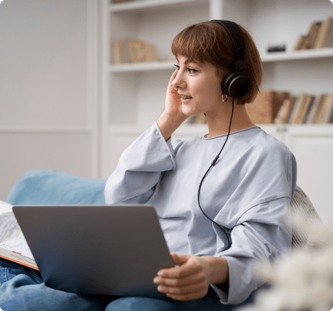 Woman using phone and laptop