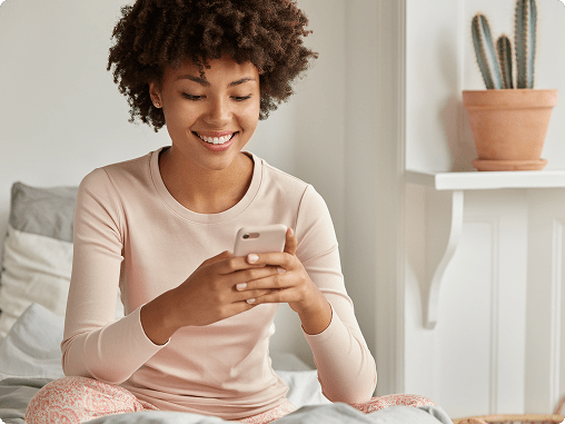 Positive black lady with afro haircut using a smartphone, representing modern service-approaches to teen therapy