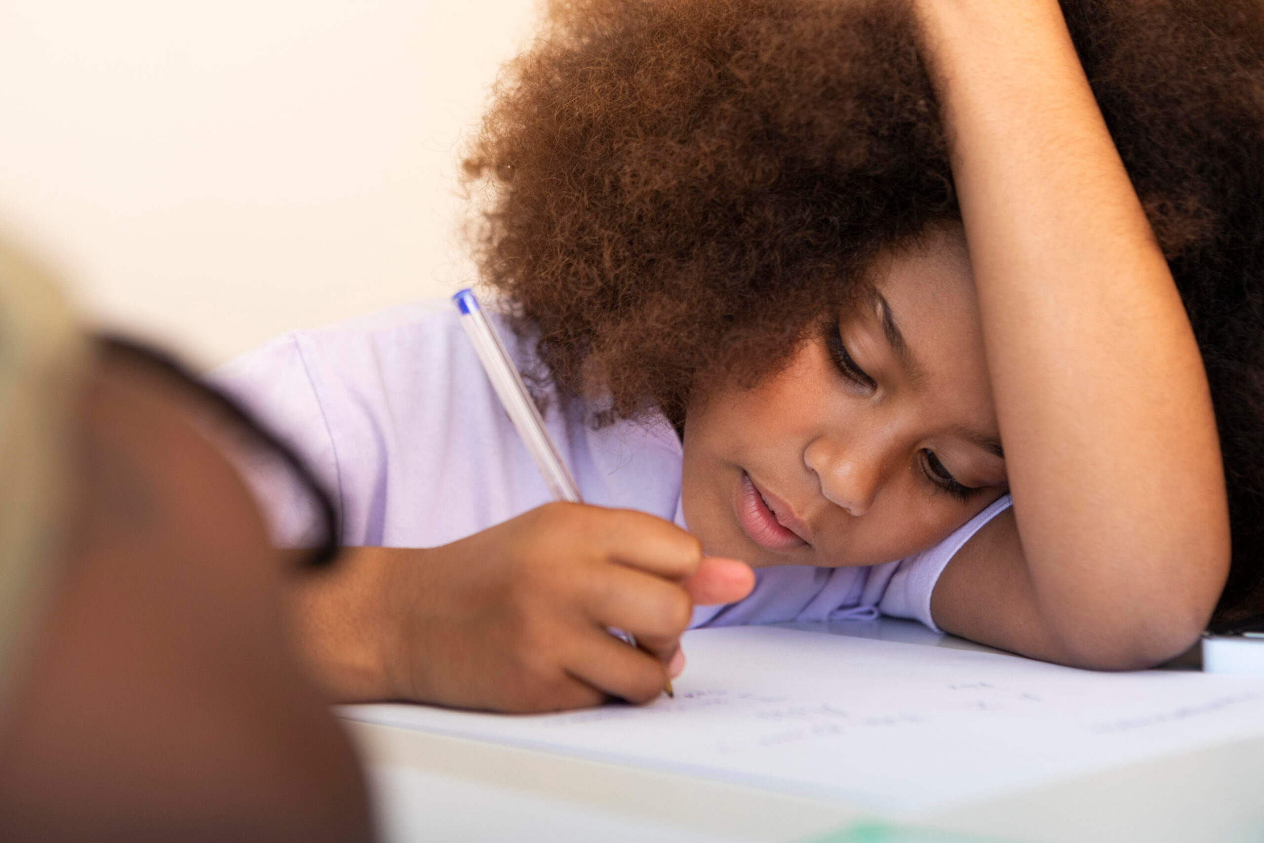 curly-haired-little-girl-doing-homework